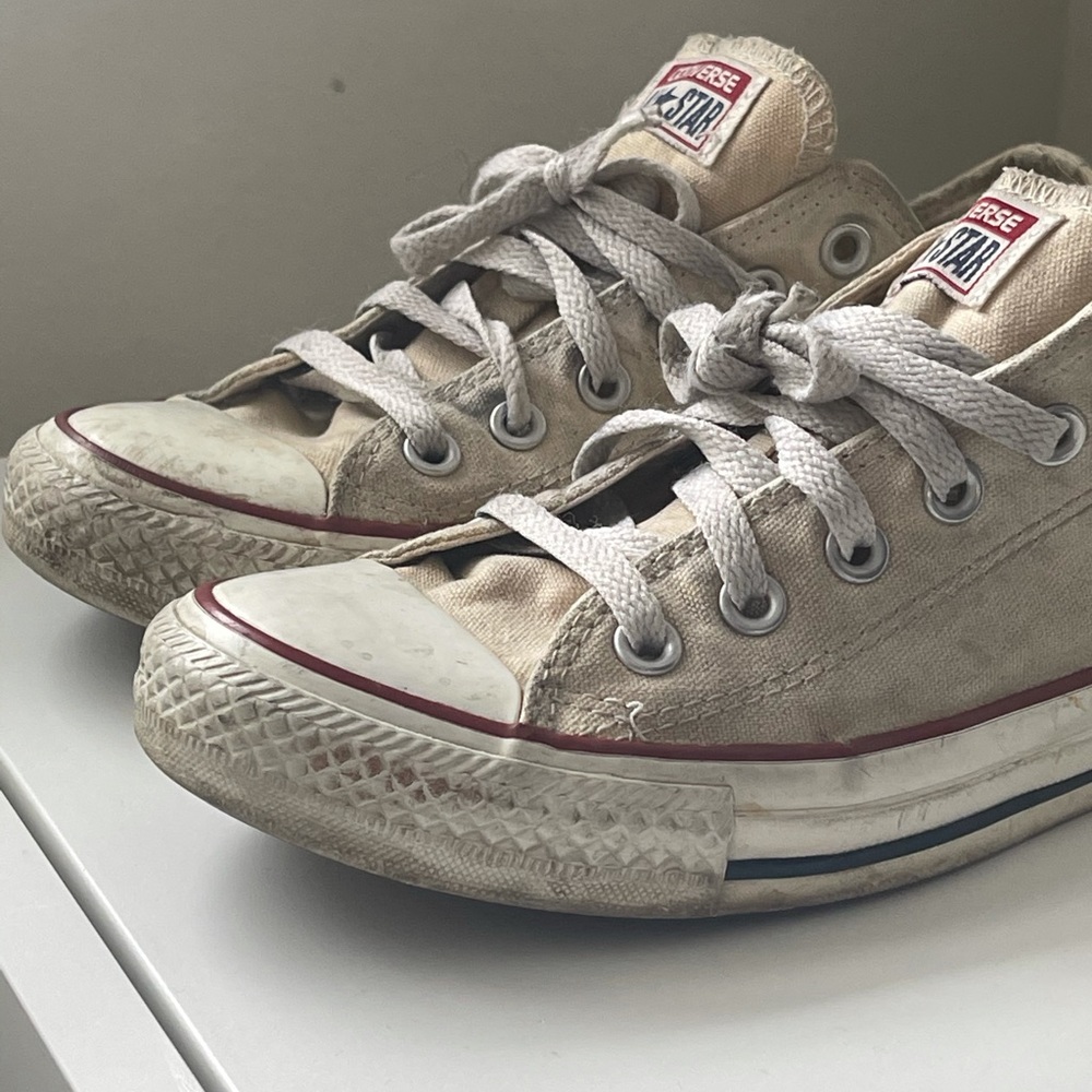 Beat up white Converse